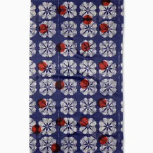 Napkin with red and white floral pattern on a blue background