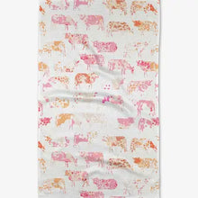 Floral patterned fabric with cows on a white background