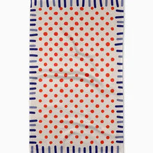 Towel with red polka dots and blue stripes on a white background